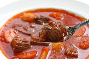 goulash soup , spoon macro shot , hungarian cuisine