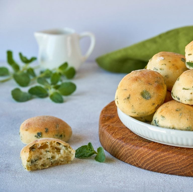 Homemade buns with fresh zaatar, oregano leaves